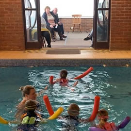 Pre-School classses with parents watching from waiting area